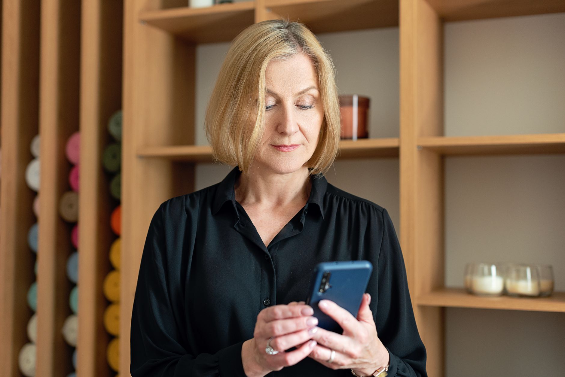 a senior woman adding an email account on a smartphone with the settings screen open