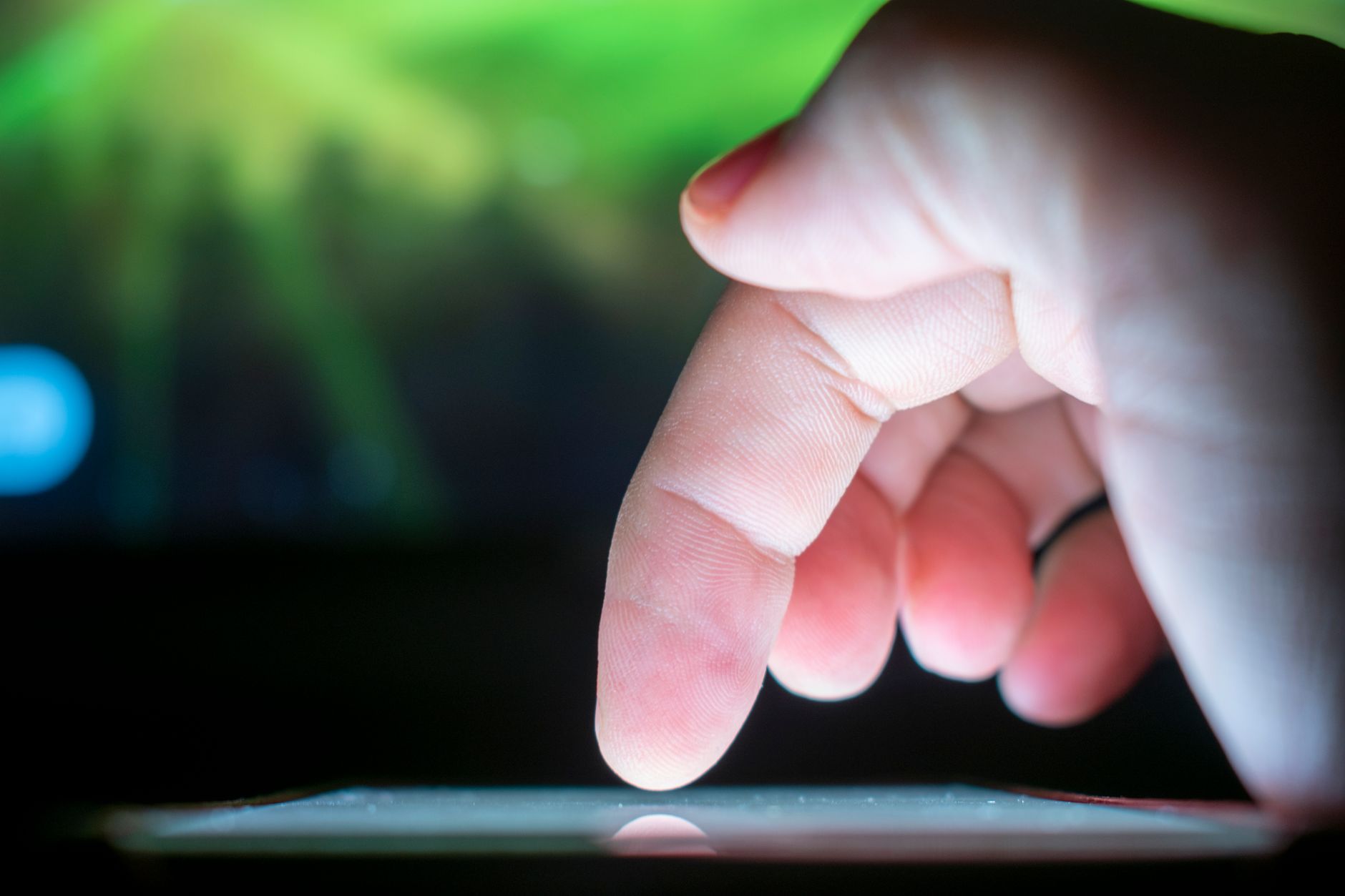 an older adult practicing a tap gesture on a tablet screen