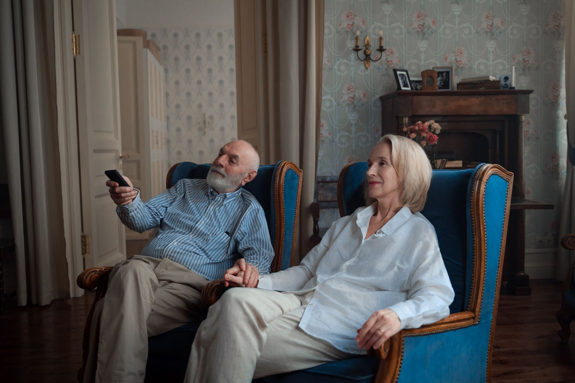 Senior holding an Amazon Fire TV Stick remote while a television is on