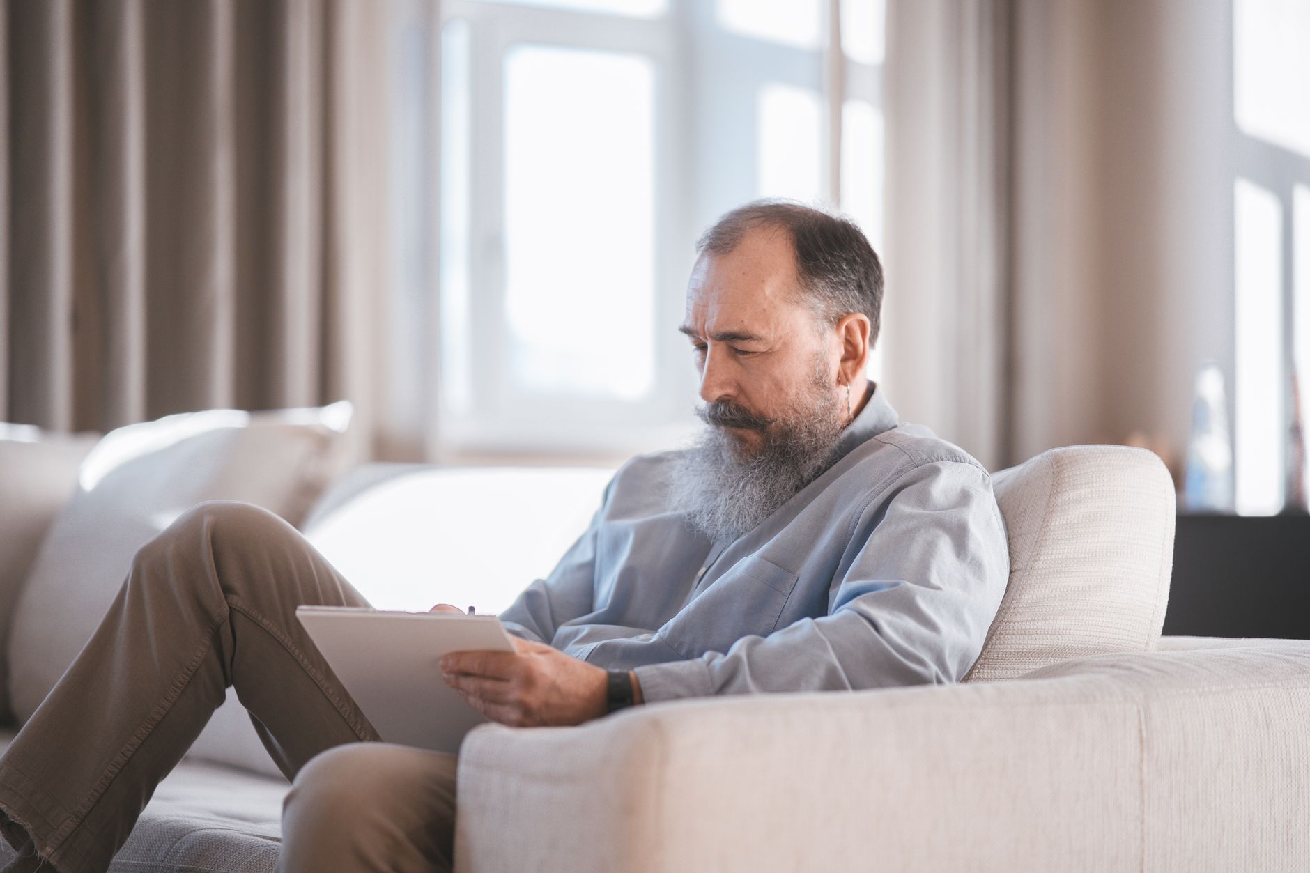 a senior adjusting privacy settings on a tablet at home